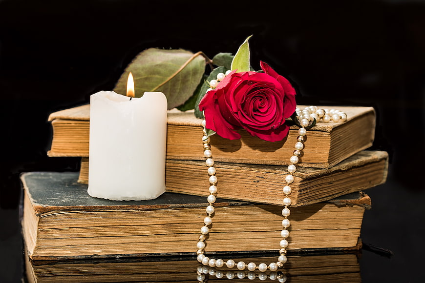 Vintage Books with Red Rose, Candle, and Pearl Necklace