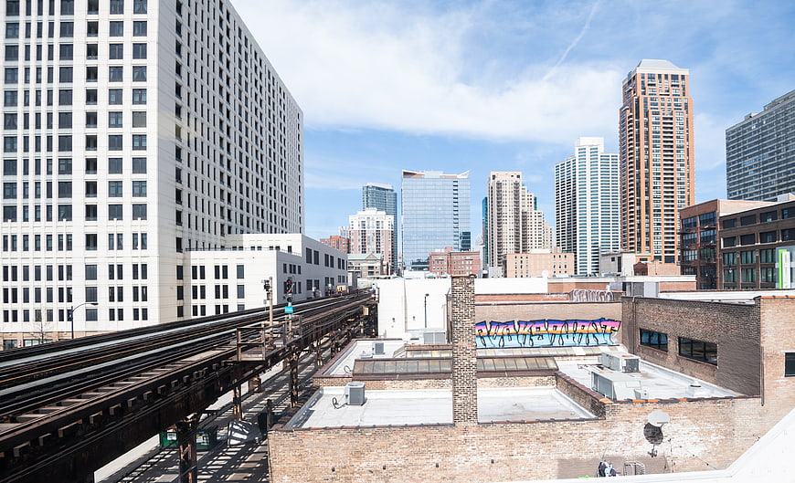 Urban Cityscape with Elevated Train Tracks and Skyscrapers