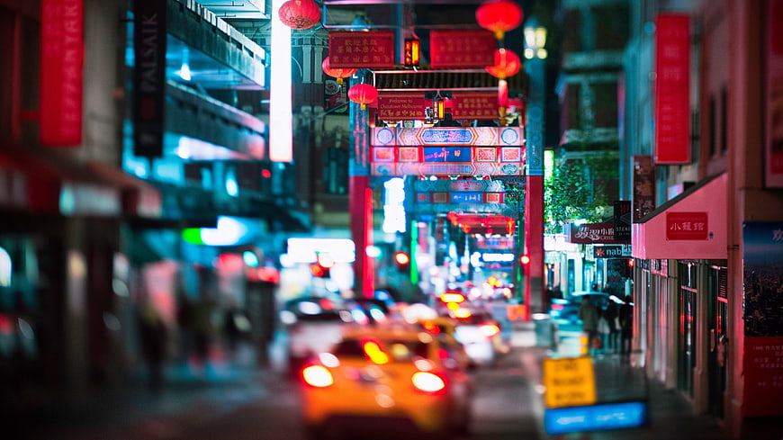 Nighttime Chinatown Street View With Red Lanterns And City Traffic