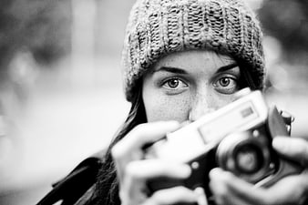 Woman with Knit Beanie Holding Vintage Camera