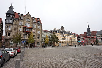 Wide cobblestone square in Eisenach, Germany with historic buildings