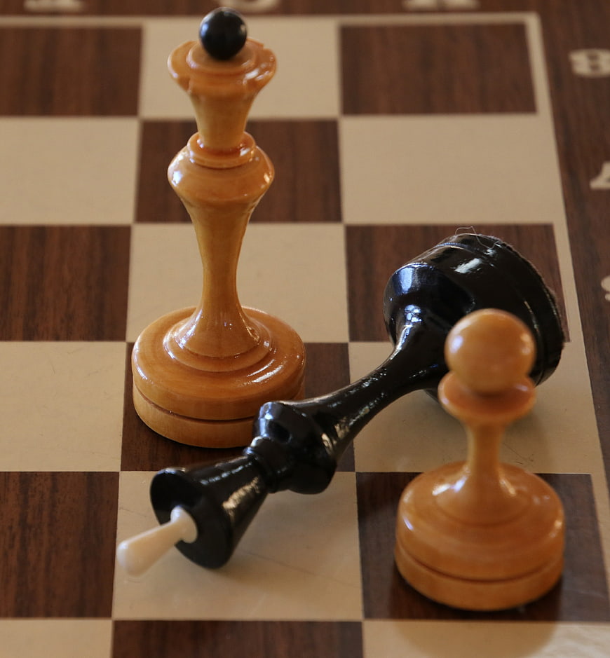 Wooden Chess Pieces on Checkered Board