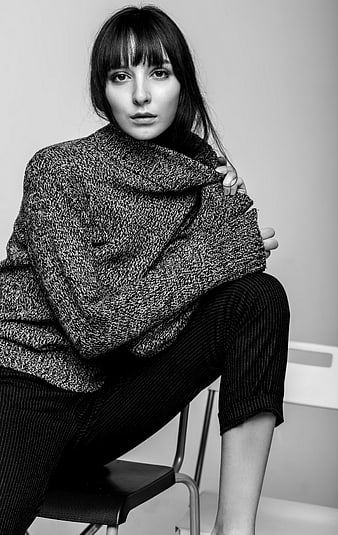 Black and white portrait of woman in oversized knit sweater