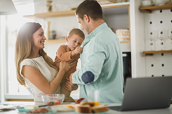 Happy Family with Toddler in Bright Modern Kitchen