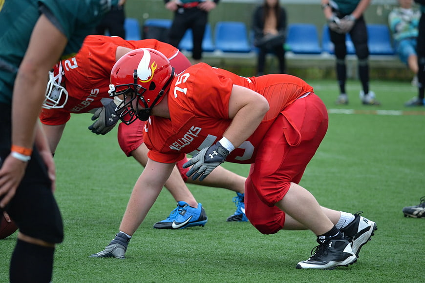 American Football Players in Red Uniforms Lining Up