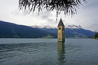 Bell Tower of Resia Lake in the Alps