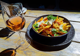 Nachos with Sour Cream and Rosé Wine on Wooden Table