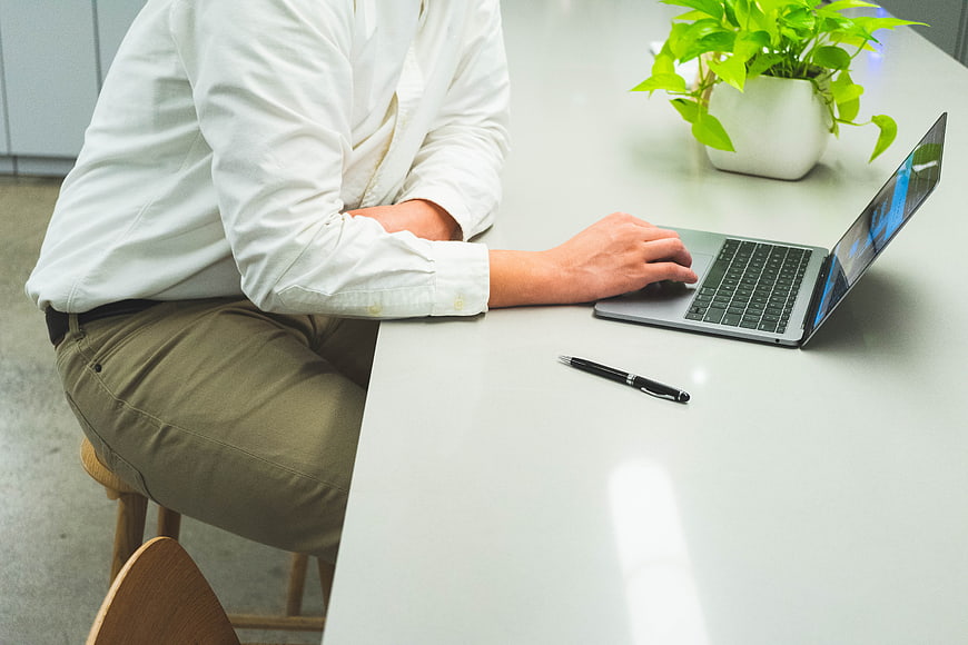 Person working on laptop at modern office desk