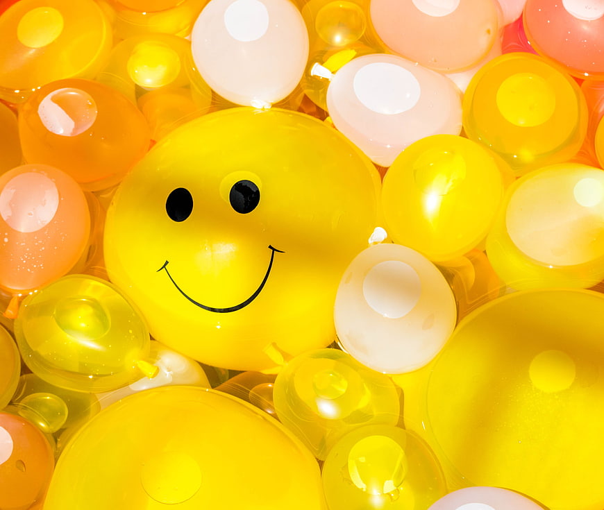 Yellow Smiley Balloon Surrounded By Colorful Party Balloons