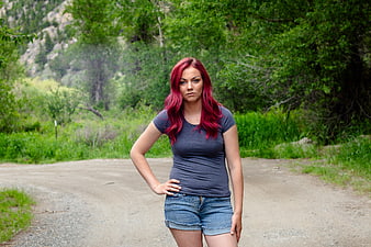 Woman with Red Hair Standing on Dirt Road in Nature