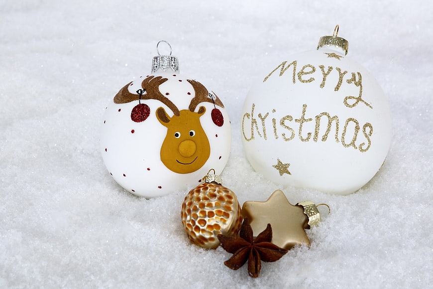 Christmas ornaments in snow with reindeer and Merry Christmas text