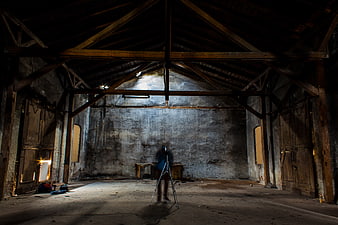 Abandoned Barn Interior with Photographer and Tripod