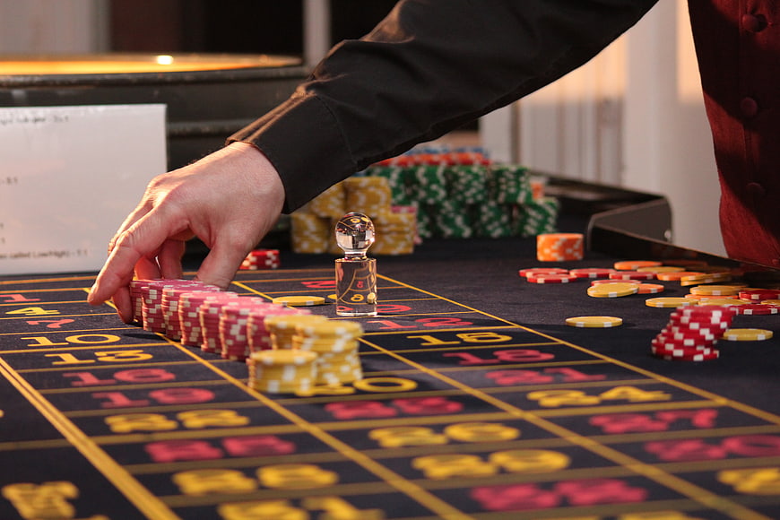 Croupier Hand Placing Chips on Roulette Table