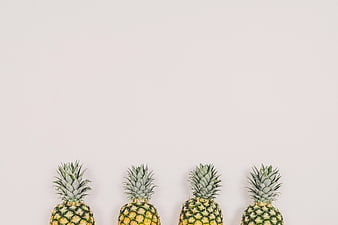 Minimalist Row of Pineapples on White Background