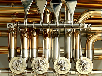 Close-up of brass tuba valves and silver pistons
