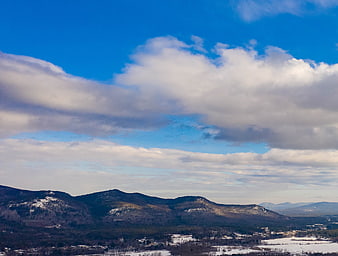Winter mountain landscape with snow and blue sky