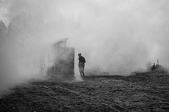 Soldier in foggy battlefield reenactment