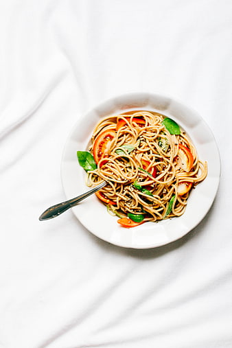 Top View of Spaghetti with Tomatoes and Basil on White
