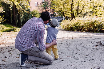 Father and Toddler Walking in Park