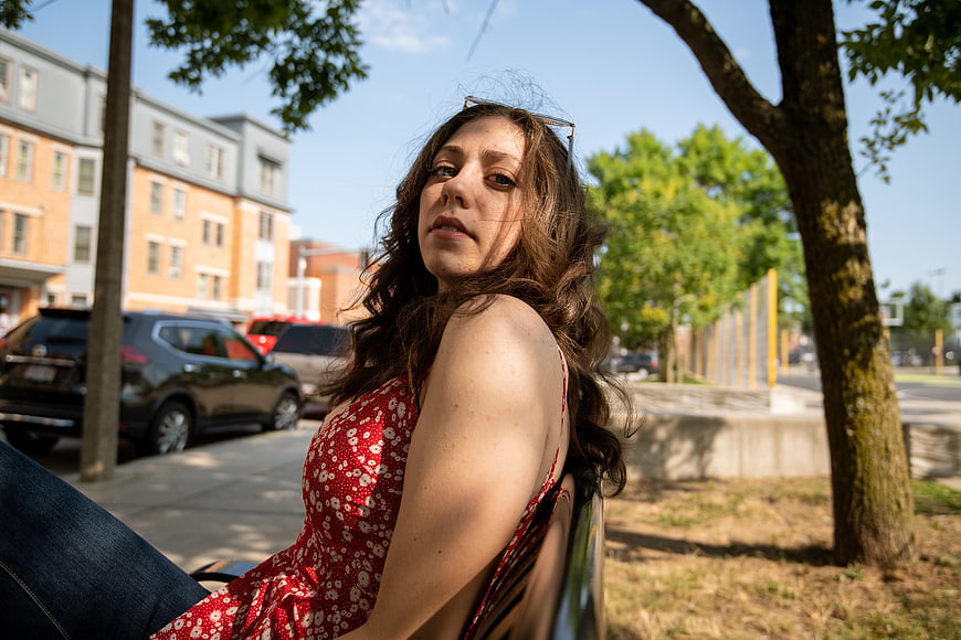 Young Woman in Red Dress Sitting on Park Bench