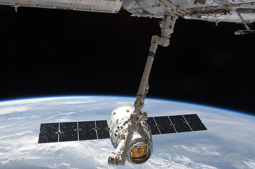 Spacecraft Docked at International Space Station Over Earth