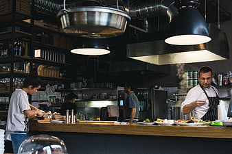 Busy restaurant kitchen with chefs preparing food
