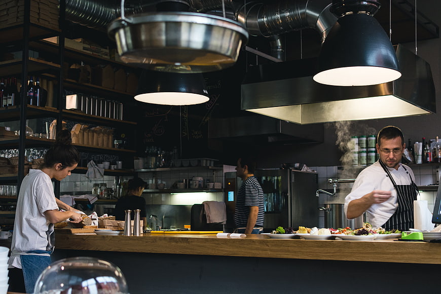 Busy restaurant kitchen with chefs preparing food