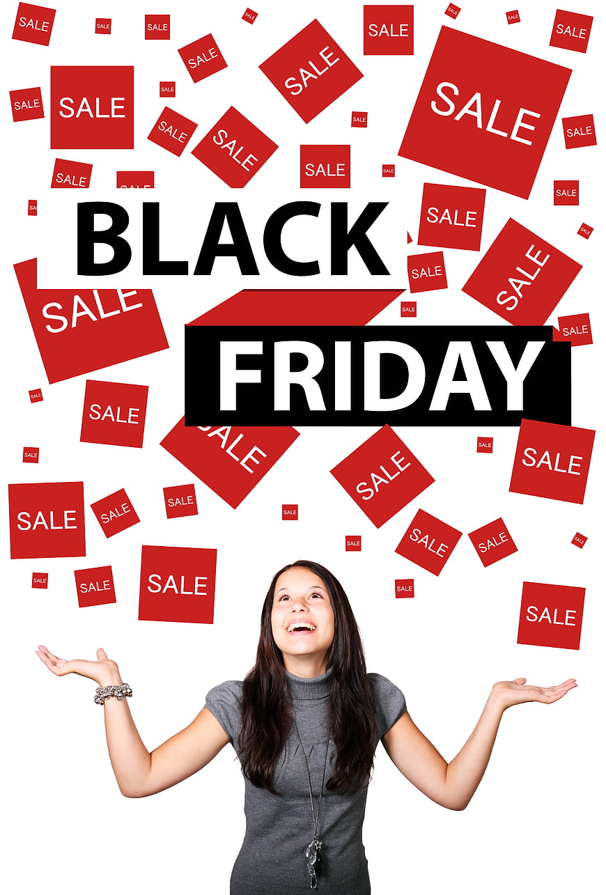 Woman celebrating Black Friday sale with floating red tags