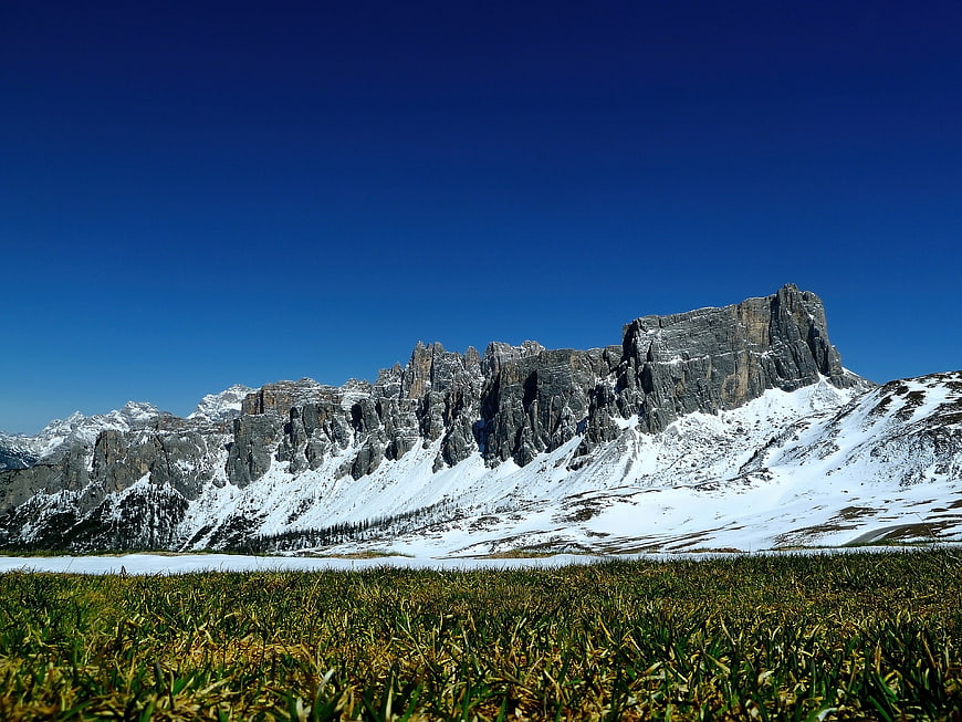 Snowy Dolomites Mountain Range with Alpine Meadow Foreground