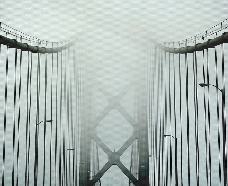 Golden Gate Bridge in thick fog with vertical cables