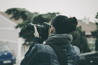 Woman Photographer Taking Photo with DSLR Camera