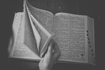 Hand Turning Page of Vintage Dictionary