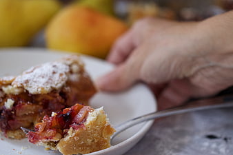 Close-up of homemade fruit pie slice on white plate