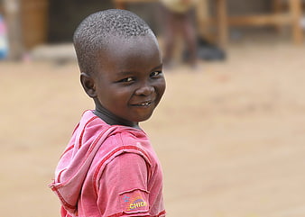 Smiling African Boy Portrait In Pink Hoodie