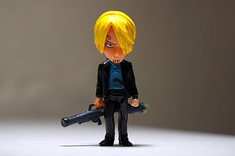 Anime Character Figurine With Yellow Hair And Black Suit
