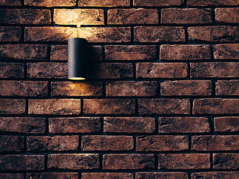 Modern Black Sconce on Textured Brick Wall Background