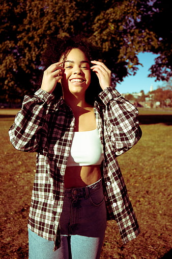 Happy Woman in Plaid Shirt Smiling in Park