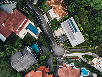 Aerial view of luxury villas with swimming pools and lush greenery