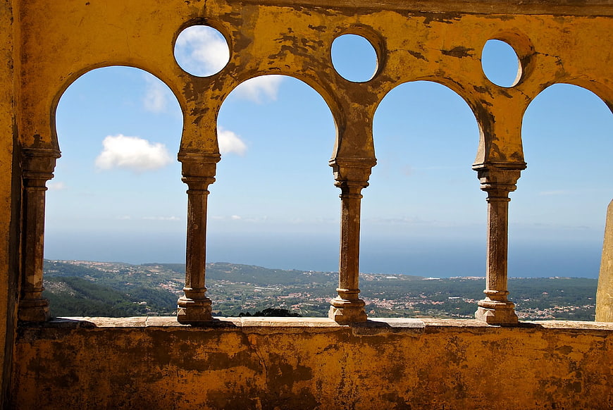 View Through Yellow Arched Balcony to Coastal Landscape