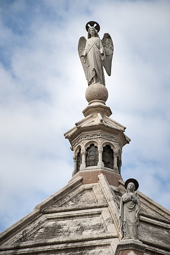 Angel Statue on Church Dome Against Cloudy Sky