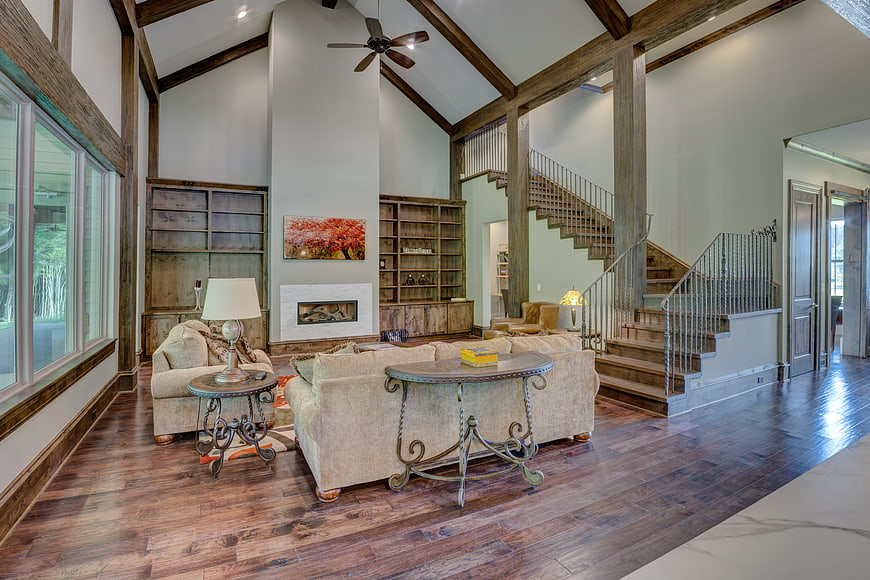 Luxury Living Room With Vaulted Ceiling And Wooden Staircase