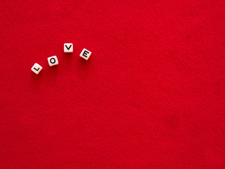 White Dice Spelling Love on Red Background