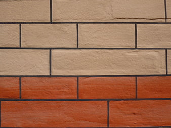 Textured beige and orange painted brick wall pattern
