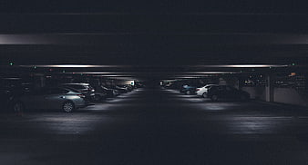 Dark Underground Parking Garage with Parked Cars