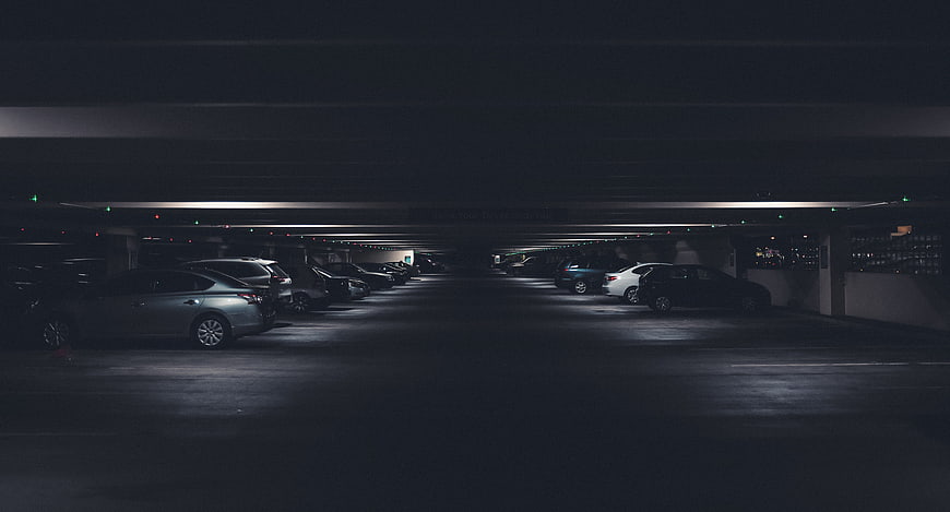 Dark Underground Parking Garage with Parked Cars
