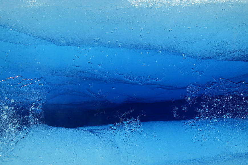 Abstract Blue Ice Texture With Bubbles And Frozen Water Layers