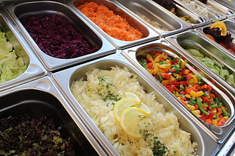 Fresh salad bar buffet with colorful vegetables in metal trays