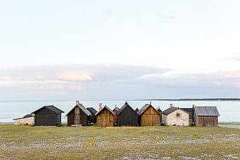 Row of rustic wooden beach huts by the sea