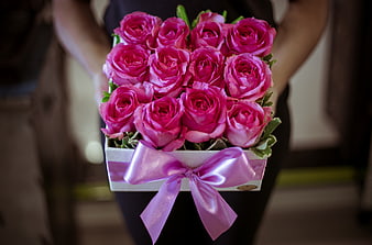 Bouquet of vibrant pink roses in a white gift box