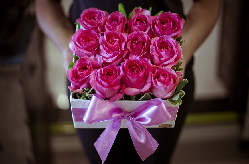 Bouquet of vibrant pink roses in a white gift box